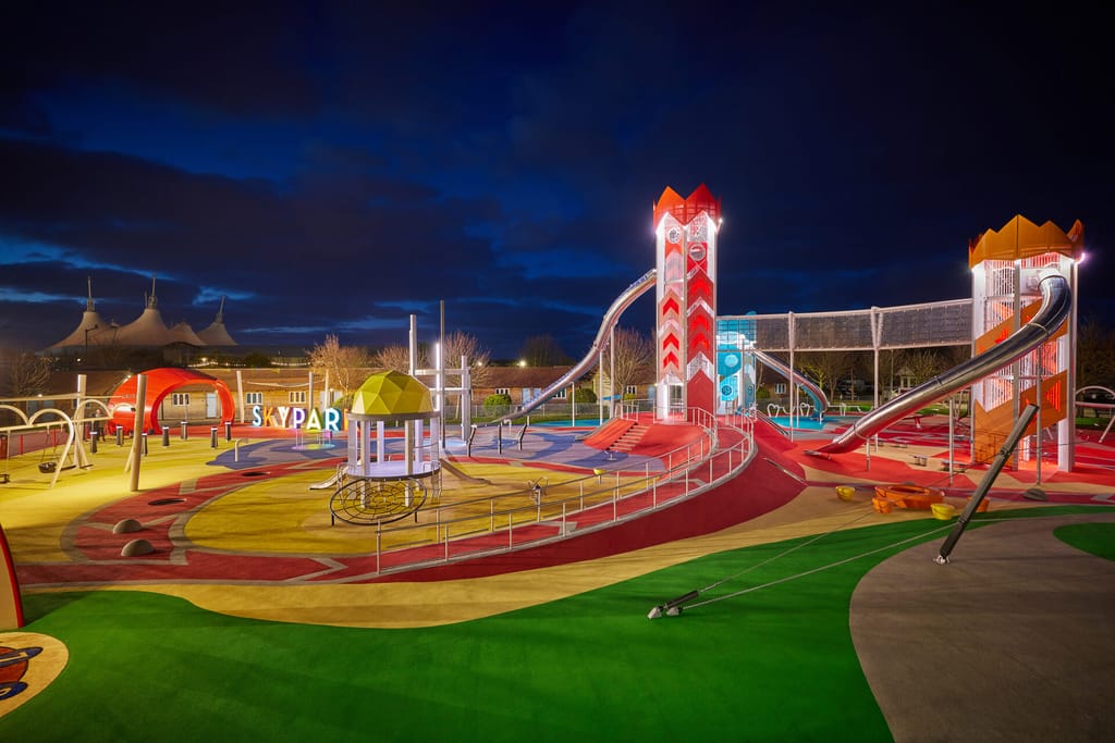 Large destination playground with extensive wet-pour surfacing under heavy, all-season use