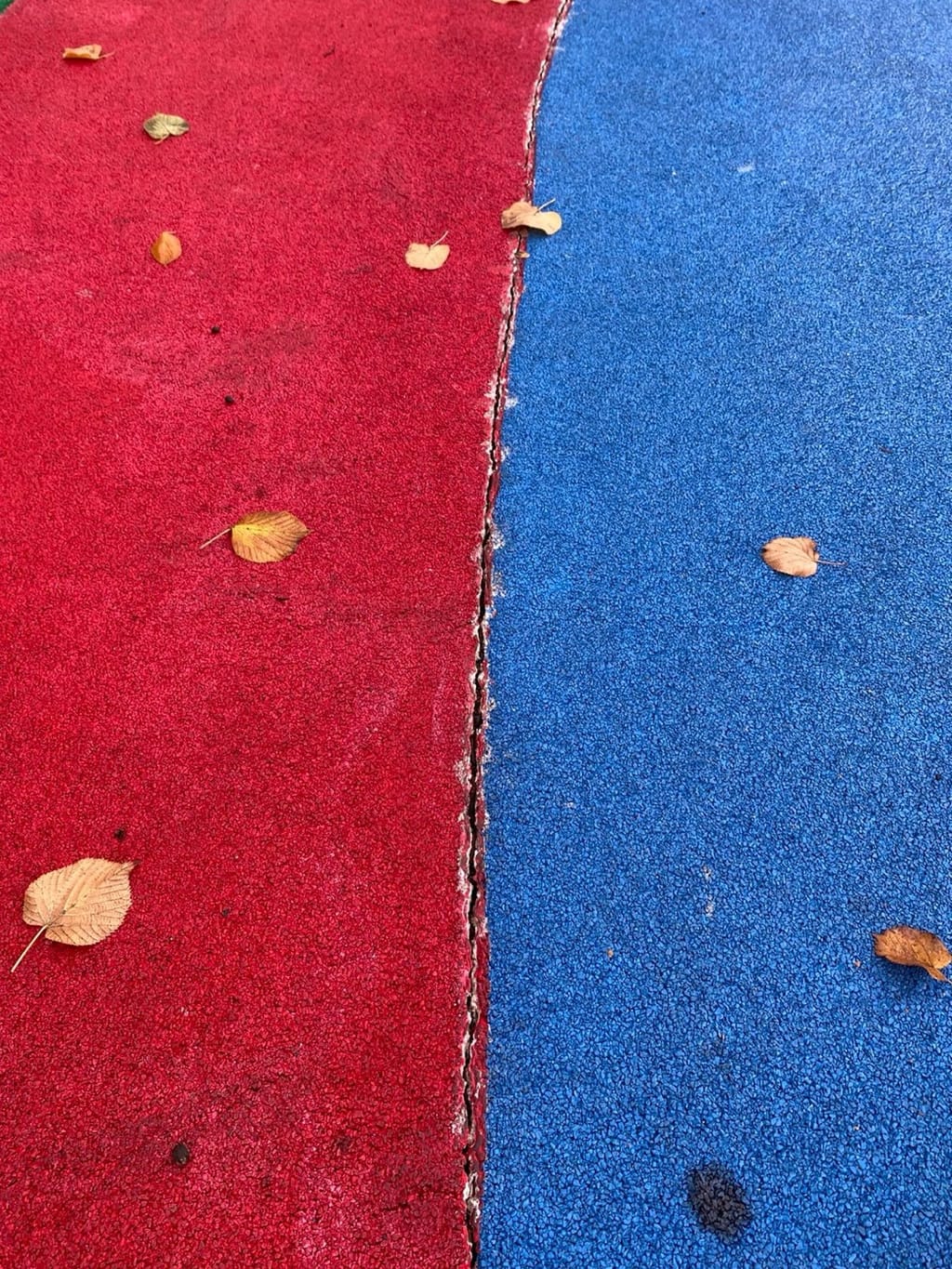 Crack running along a joint in an EPDM wet-pour surface