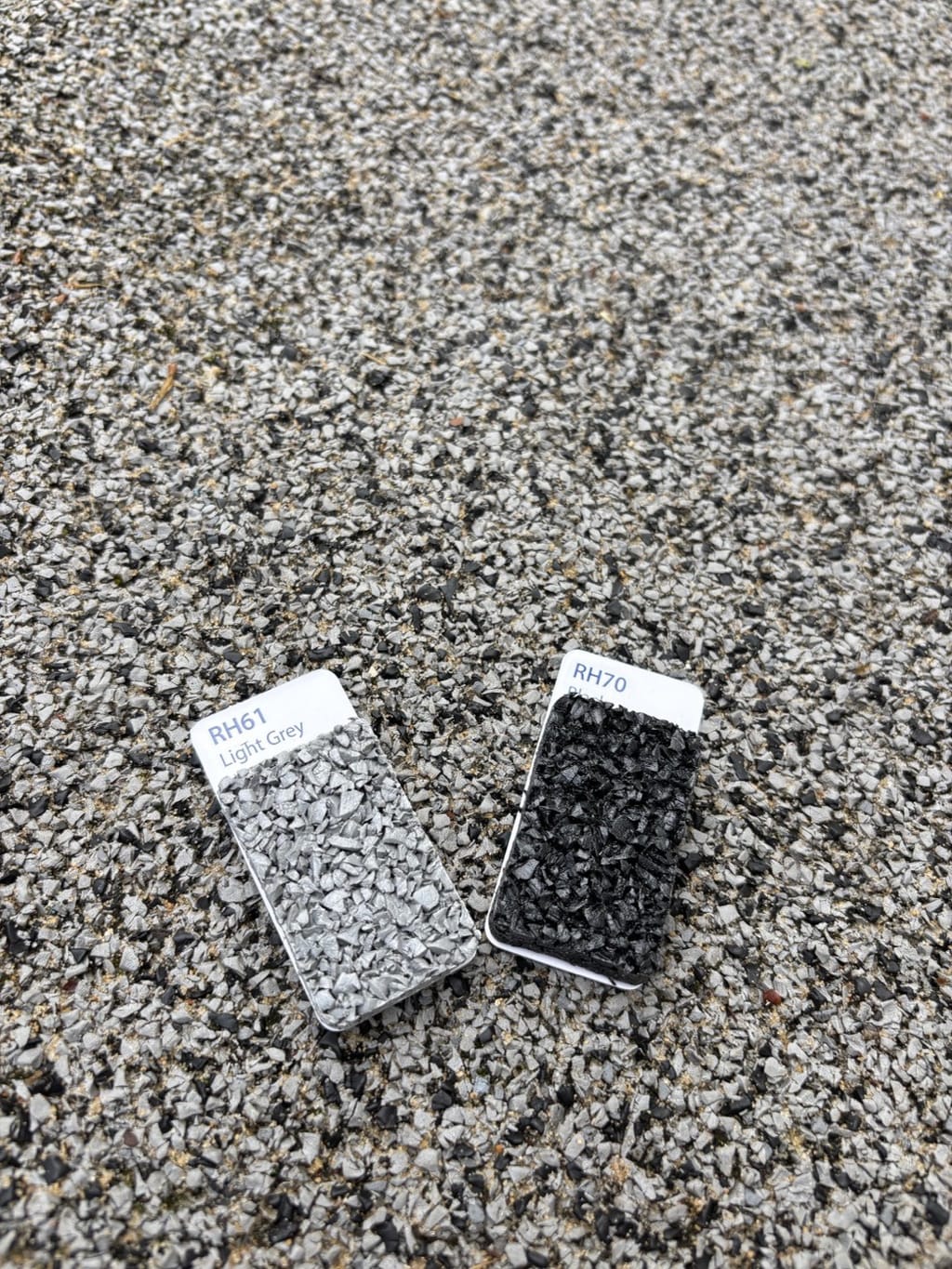 Rosehill TPV surface installed in Sydney in 2009 with a current factory swatch card held against it &mdash; colours still matching after seventeen years